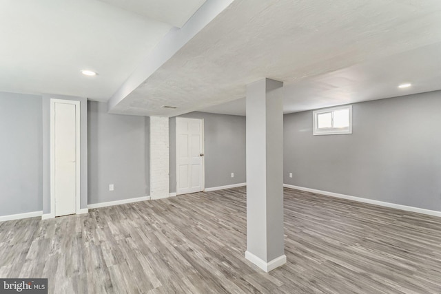 basement featuring light hardwood / wood-style flooring