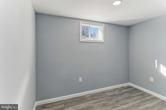 empty room with hardwood / wood-style flooring