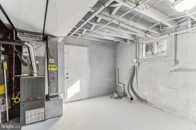 basement featuring gas water heater and heating unit