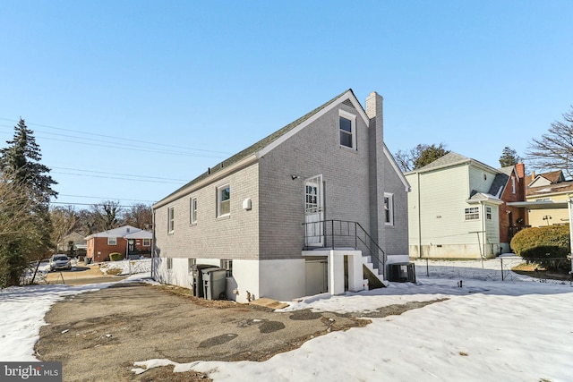 view of snow covered exterior featuring central AC