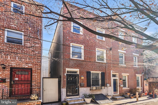 view of front facade featuring brick siding and entry steps