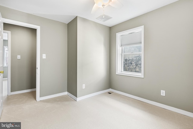 unfurnished bedroom with ceiling fan and light colored carpet