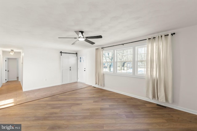 spare room with ceiling fan and wood-type flooring