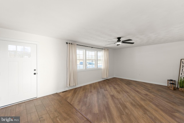 entrance foyer with ceiling fan and dark wood-type flooring