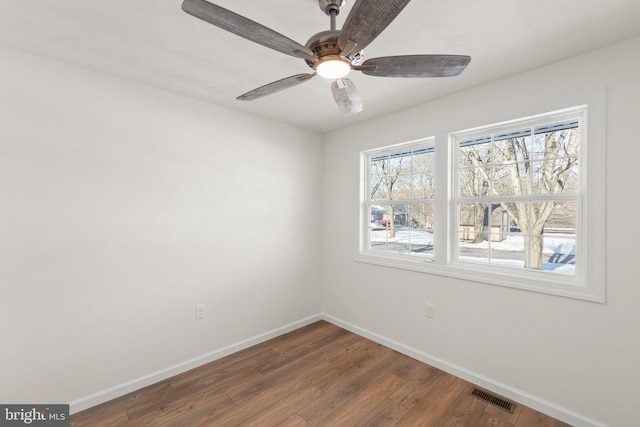 empty room with ceiling fan and hardwood / wood-style flooring