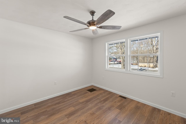 empty room featuring ceiling fan and dark hardwood / wood-style floors