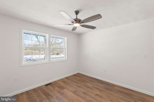 unfurnished room with dark hardwood / wood-style flooring and ceiling fan