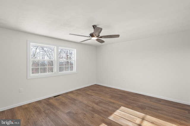 unfurnished room featuring ceiling fan and dark hardwood / wood-style floors