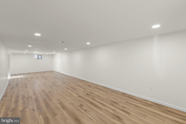 basement with light hardwood / wood-style floors