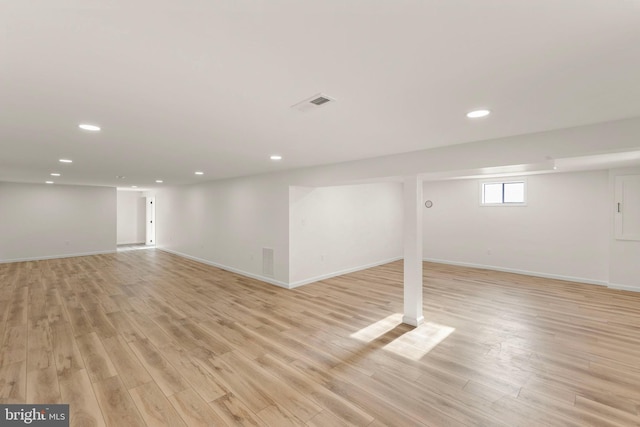 basement with light hardwood / wood-style floors