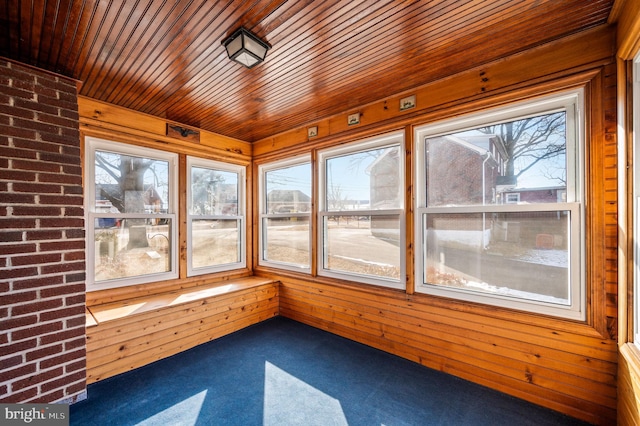 unfurnished sunroom featuring wooden ceiling