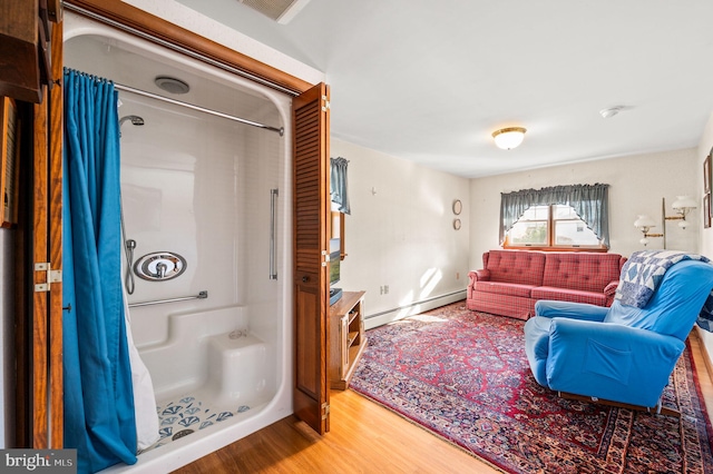 living room featuring a baseboard radiator and hardwood / wood-style flooring