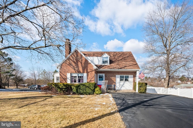 new england style home with a front lawn