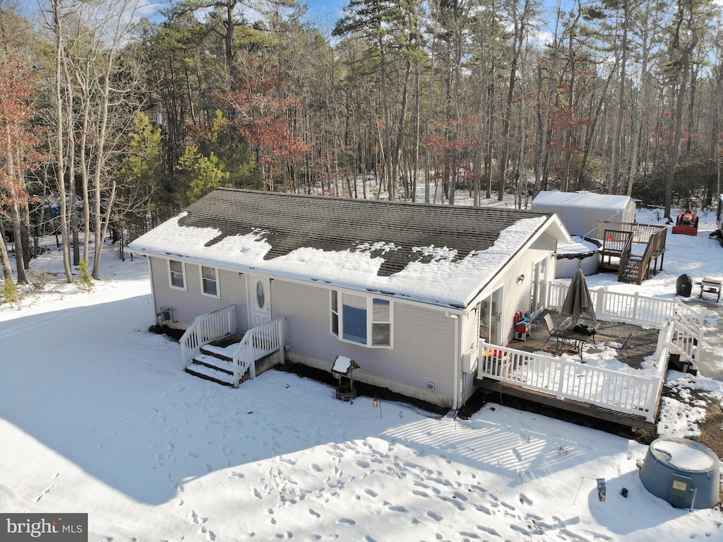 snow covered house with a deck