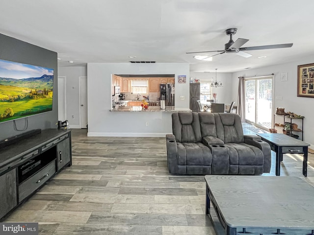 living room featuring ceiling fan and wood-type flooring