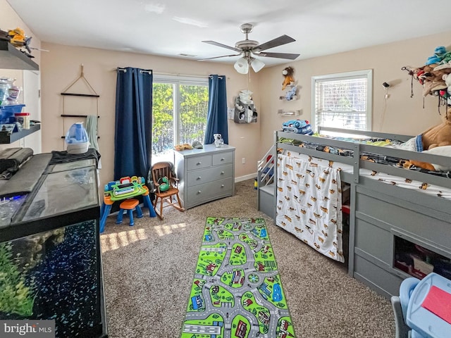 carpeted bedroom featuring multiple windows and ceiling fan