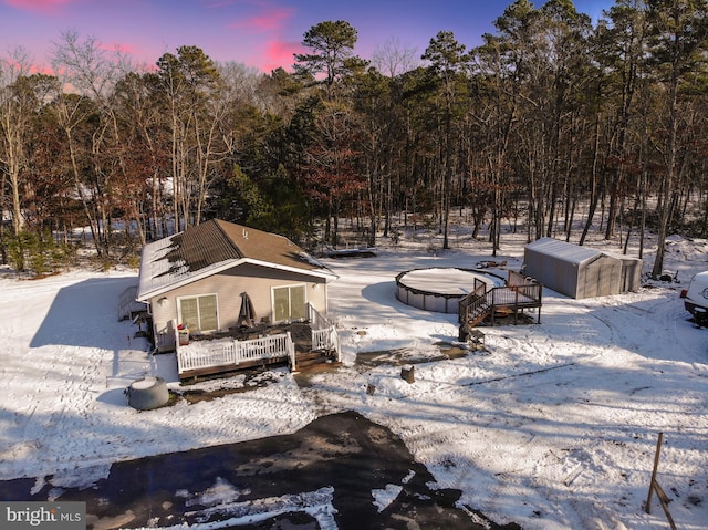 view of property's community with a wooden deck and an outdoor structure