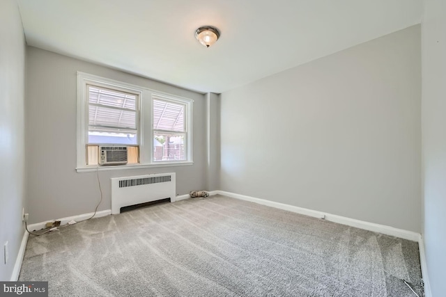 carpeted spare room with radiator and cooling unit