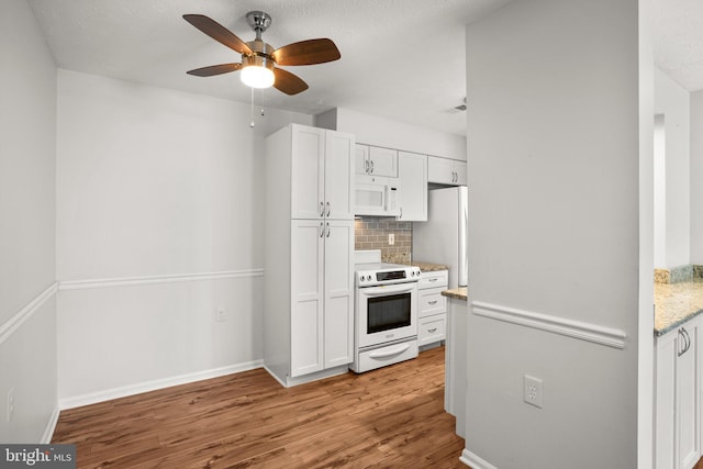 kitchen with white cabinets, ceiling fan, light wood-type flooring, tasteful backsplash, and electric stove