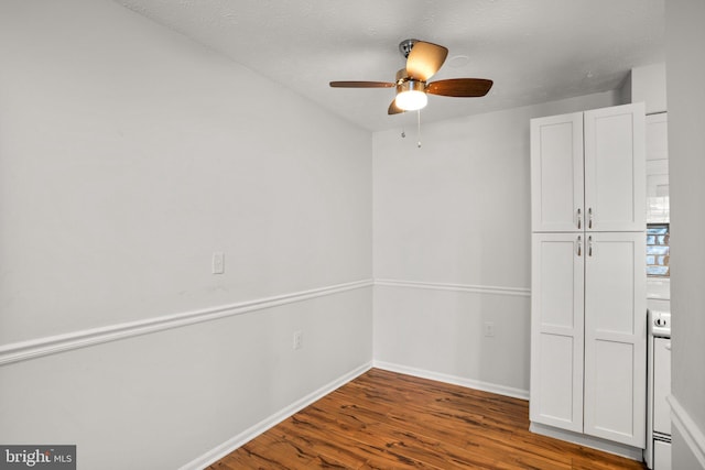 spare room with hardwood / wood-style flooring, a textured ceiling, and ceiling fan