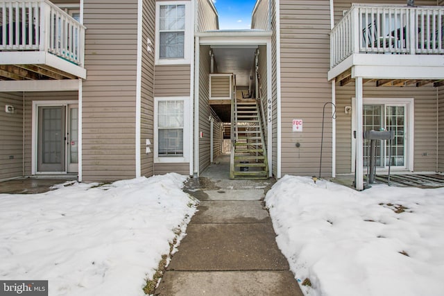 view of snow covered property entrance