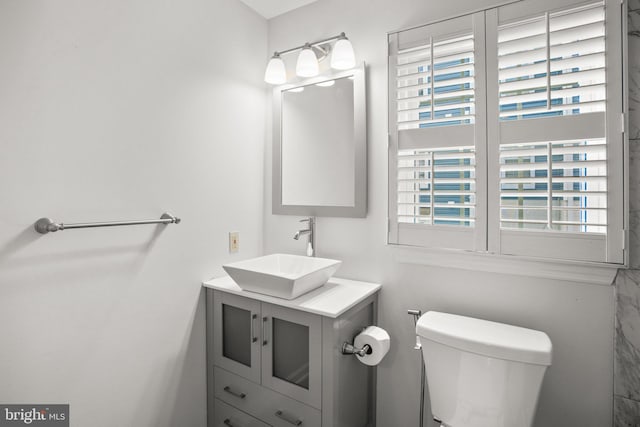 bathroom featuring vanity and toilet