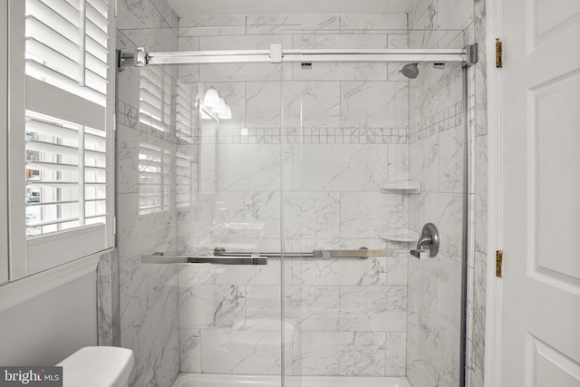 bathroom with a shower with shower door