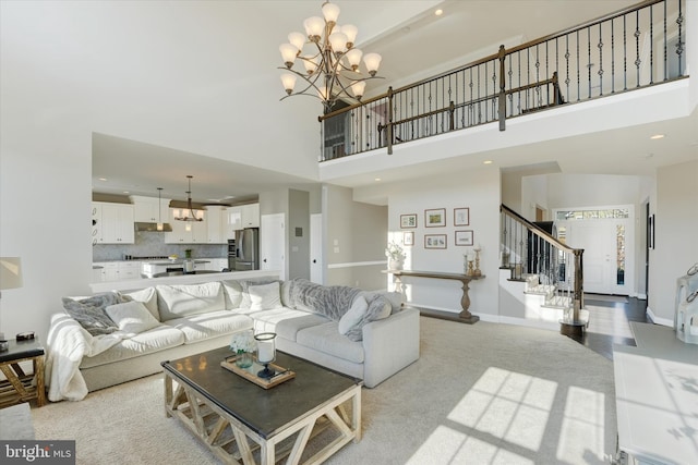 living room featuring a chandelier and a high ceiling