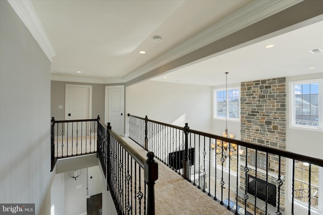 hallway with a chandelier and ornamental molding