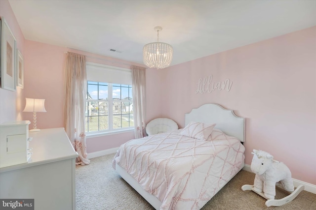 carpeted bedroom featuring a notable chandelier