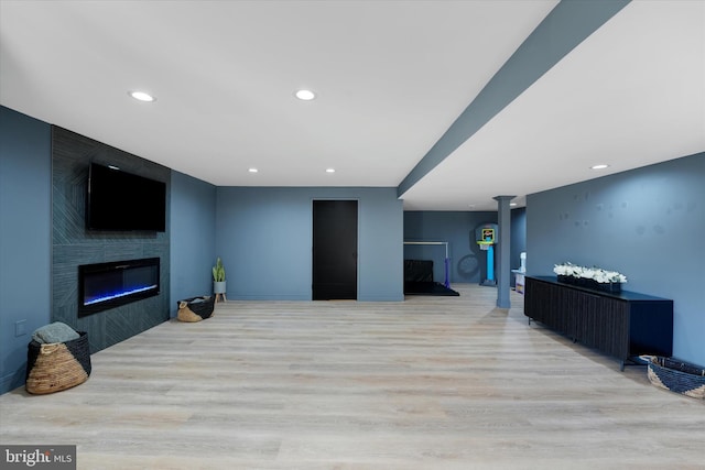 living room featuring a fireplace and light hardwood / wood-style floors