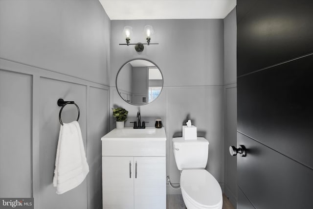 bathroom featuring toilet and vanity