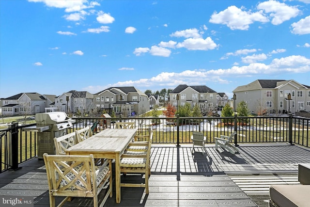 wooden deck featuring area for grilling and a water view