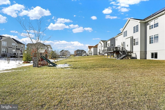 view of yard with a wooden deck and a playground