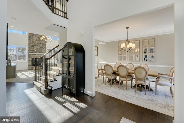 dining room featuring dark hardwood / wood-style flooring, crown molding, and a notable chandelier