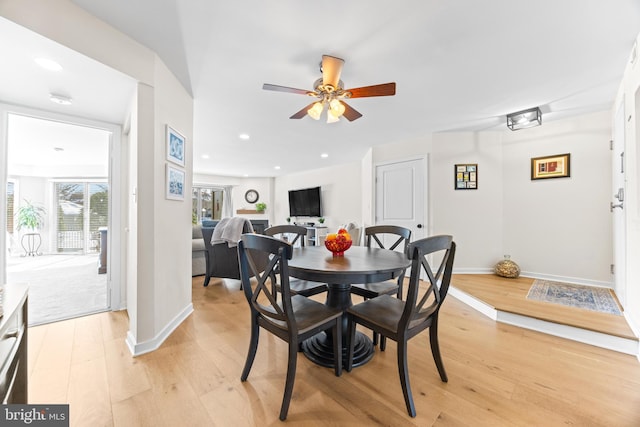 dining space with light wood-type flooring and ceiling fan