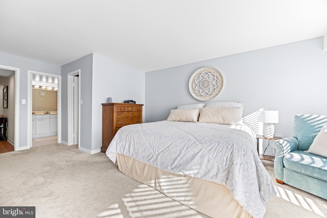 carpeted bedroom with connected bathroom