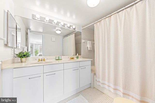 bathroom featuring tile patterned floors, shower / bath combo, and vanity