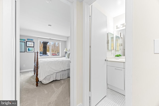 carpeted bedroom featuring ensuite bath