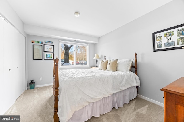 bedroom featuring a closet and light carpet