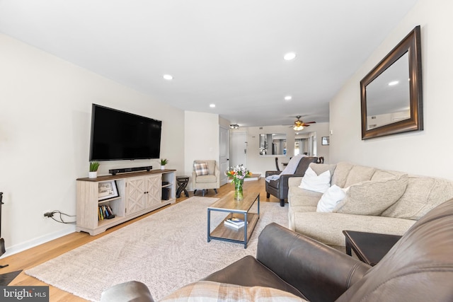 living room with ceiling fan and hardwood / wood-style flooring