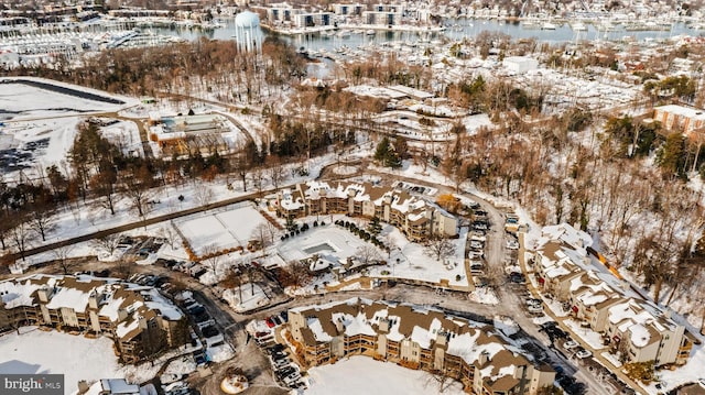 snowy aerial view featuring a water view