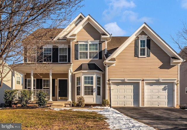 view of front of property with a garage and a porch