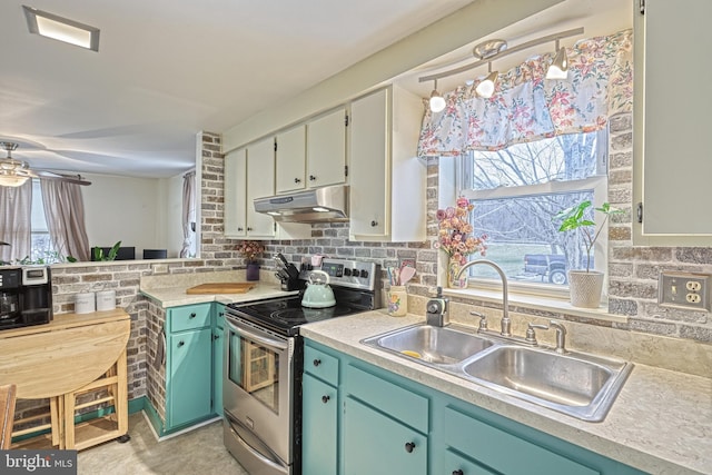 kitchen featuring ceiling fan, stainless steel range with electric cooktop, and sink