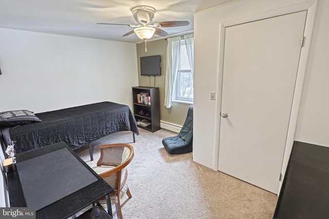 carpeted bedroom with ceiling fan and a baseboard radiator