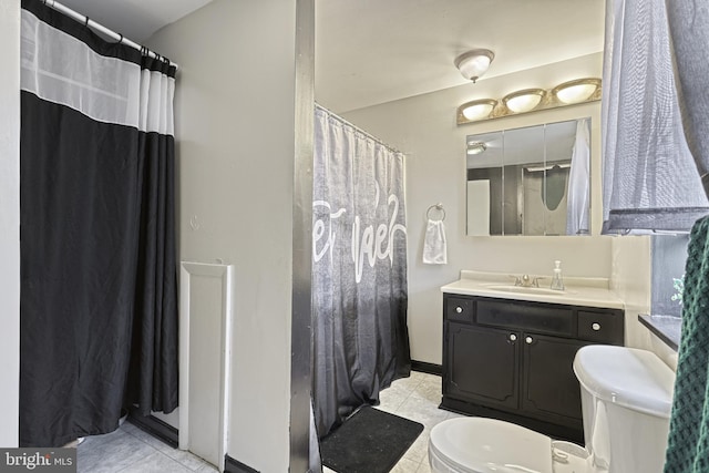 bathroom featuring tile patterned floors, vanity, and toilet