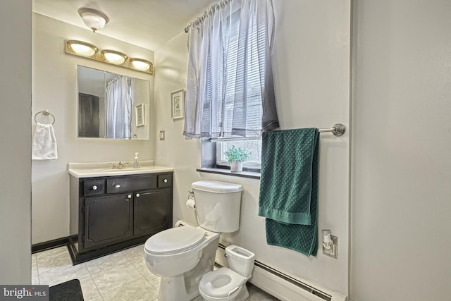 bathroom with tile patterned flooring, vanity, toilet, and baseboard heating