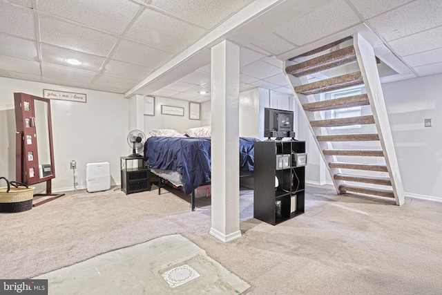 basement featuring carpet floors and a drop ceiling