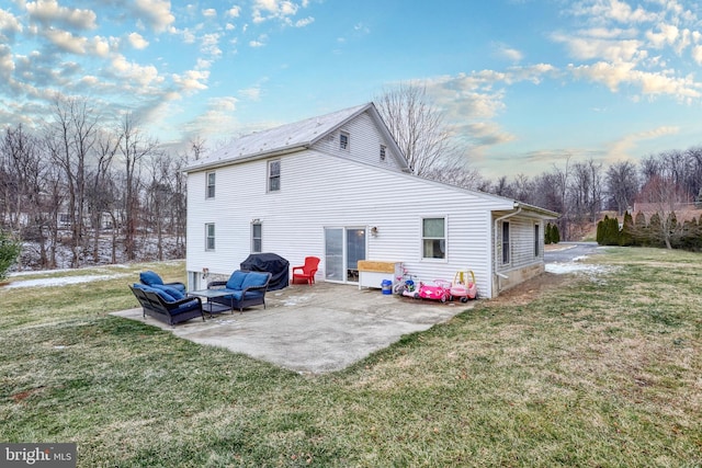 back of house featuring a lawn and a patio