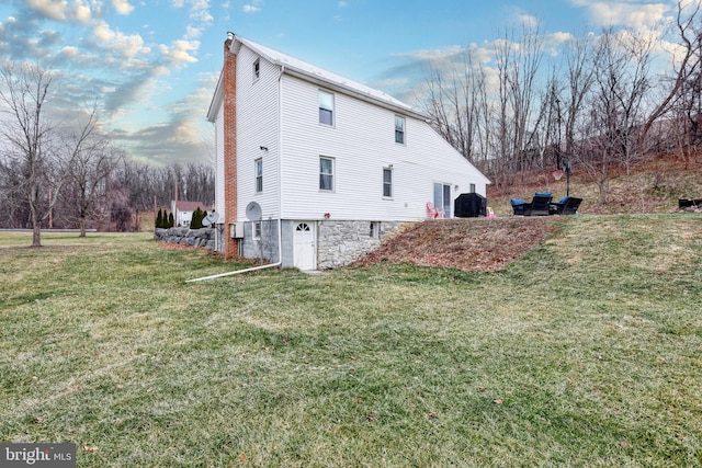 view of side of home featuring a lawn